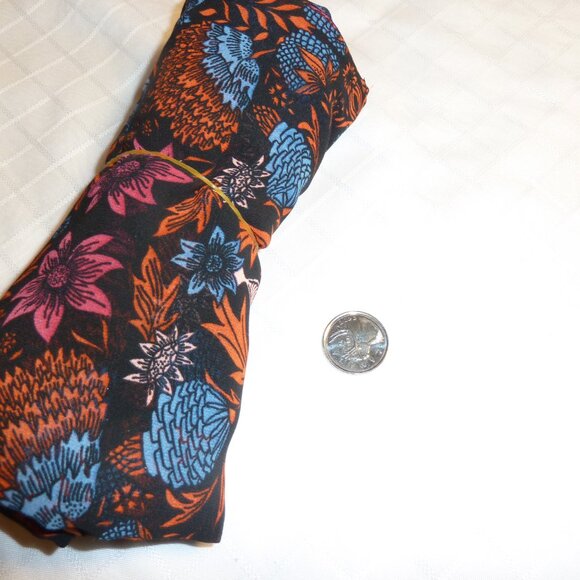 Fabric with blue, orange, red, and pink floral pattern on a black background - Picture 3 of 3